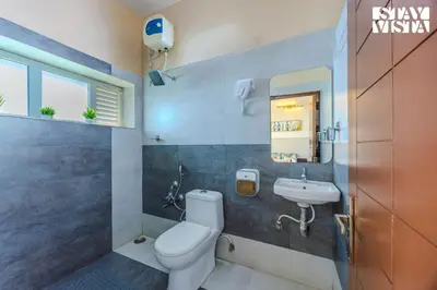 a bathroom with a toilet and a sink at Mistydawn Villas By Sunset Valley by VEO - Part of StayVista in Ooty