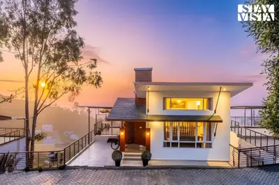 a house with a view of the ocean at Mistydawn Villas By Sunset Valley by VEO - Part of StayVista in Ooty