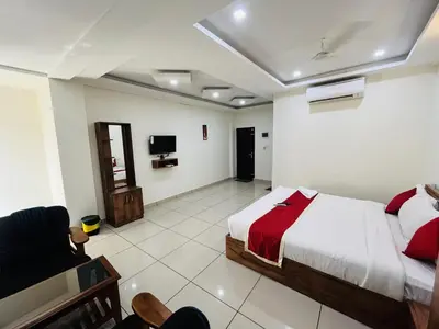 a bedroom with a bed and a tv in it at Homey - vythiri bus station in Vythiri