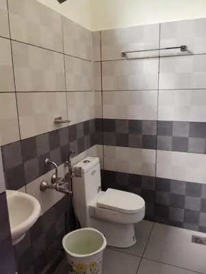 a bathroom with a toilet and a sink at Homey - vythiri bus station in Vythiri