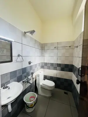 a bathroom with a toilet and a sink at Homey - vythiri bus station in Vythiri