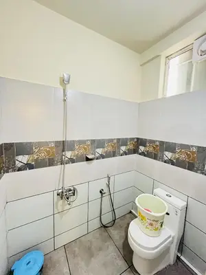 a bathroom with a toilet and a shower at Homey - vythiri bus station in Vythiri