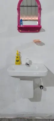 a bathroom with a white sink and a red mirror at Silent Stays in Kelakam