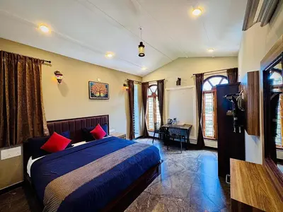 a bedroom with a bed with red pillows in it at Ever Fresh High View By Let's Inn in Ooty