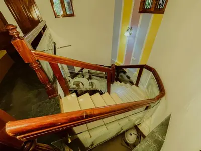an overhead view of a machine on a spiral staircase at Upavan Villa-Two KM From Aluva Metro Station in Alwaye