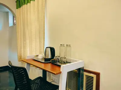 a kitchen with a table with a appliance on it at Upavan Villa-Two KM From Aluva Metro Station in Alwaye