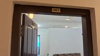 an open door with a clock on top of it at Hill palace Inn in Periya