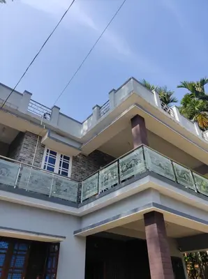 a house with a balcony on top of it at Maurya Homestay in Napoklu