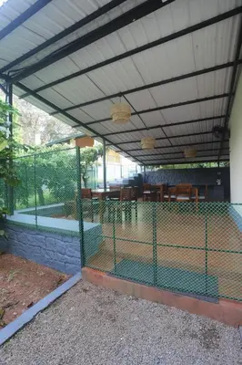 a pergola with a chicken cage in a house at Coffee Courtyard - Boutique Estate Retreat, Coorg in Kurchi