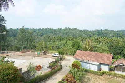 an aerial view of a house with a parking lot at Nvoyages Plantataion Stay Coorg in Madikeri