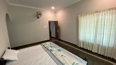an empty room with a bed and a window at Abida Mansion 4BHK Near MCP Convention Centre Irinjalakuda in Irinjālakuda