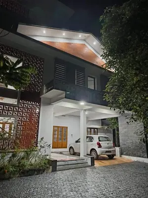 a white car parked in front of a house at Aathira Agri Homes in Trichūr