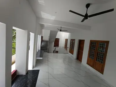 a hallway of a house with a ceiling fan at Aathira Agri Homes in Trichūr