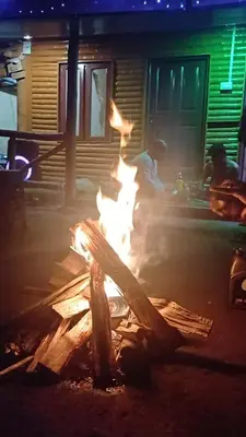 a fire in the middle of a street at night at Mud bees resort in Kanthalloor