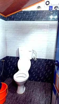 a bathroom with a white toilet in a room at Mud bees resort in Kanthalloor
