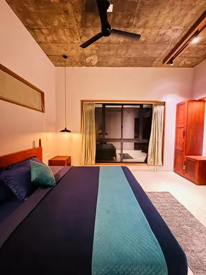 a bedroom with a large bed in a room at Hill Brown Resort in Kalpetta