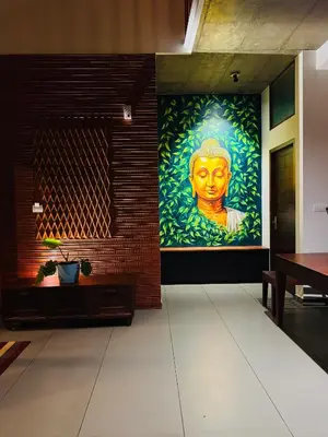 a large painting of a face on a wall at Hill Brown Resort in Kalpetta