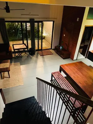 a view of a living room with a staircase at Hill Brown Resort in Kalpetta
