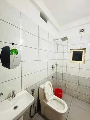 a bathroom with a toilet and a sink at Atholi Residency in Mukkam