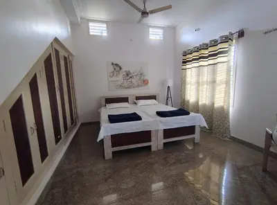 a bedroom with a bed in a room with a window at Anava Farms in Shrīrangapattana
