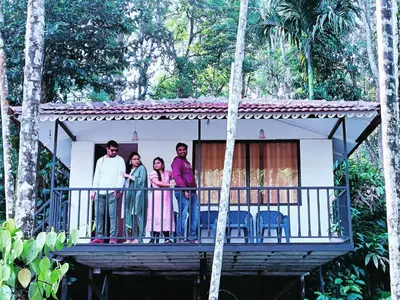 a group of people standing on the balcony of a house at DEEP ViLLA in Batheri