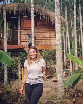 a woman standing in front of a house at DEEP ViLLA in Batheri