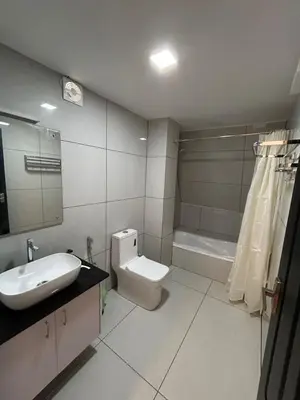 a bathroom with a sink and a toilet and a shower at Mangalath River View Resorts in Kodanad