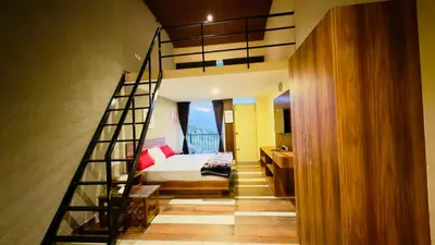 a staircase leading to a bedroom with a bed at Teyt Grand View in Ketti