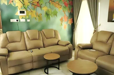 a living room with a couch and a table at Karthika Residency Parakkadavu in Nedumbassery