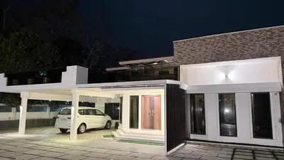 a white van parked in front of a house at night at Karthika Residency Parakkadavu in Nedumbassery