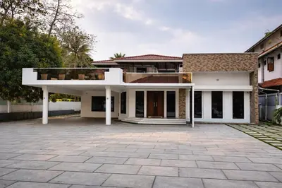 a house with a large driveway in front of it at Karthika Residency Parakkadavu in Nedumbassery