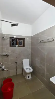 a bathroom with a toilet and a sink at Dreamland kizhunna beach homestay in Kannur