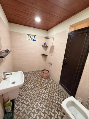 a bathroom with a sink and a toilet and a shower at Tusker & Gaur - Bandipur
