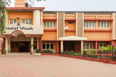 a hotel with a brick driveway in front of a building at Hotel Vivek in Coonoor