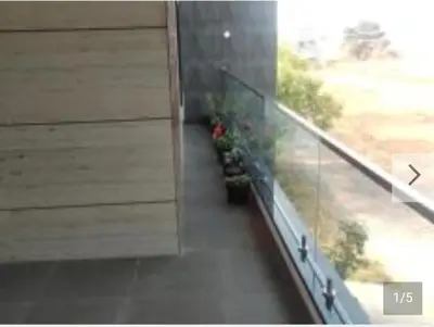 a balcony with flowers on the side of a building at Shan Home Stay in Mysore