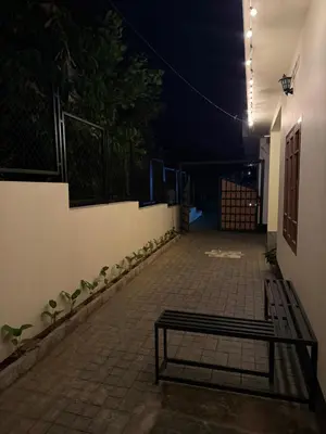 a bench sitting on a patio at night at Ethnic Family Spot Wayanad in Kenichira