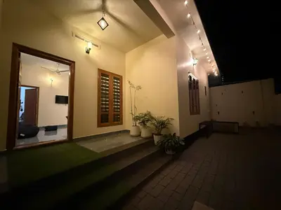 a hallway of a building with plants and lights at Ethnic Family Spot Wayanad in Kenichira