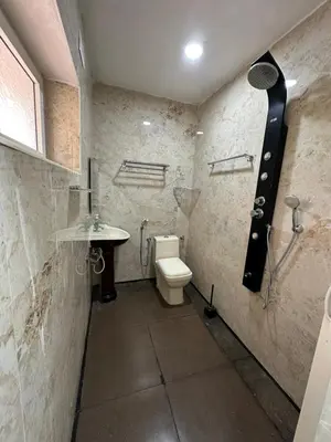 a bathroom with a toilet and a sink at Rose villa in Coimbatore