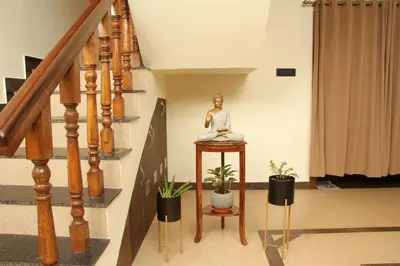 a statue on a table in a hallway with potted plants at Luxurious Private Vantage Villa - Kotagiri in Kotagiri