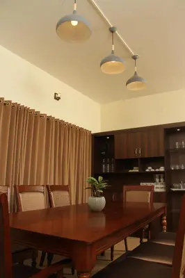 a dining room with a wooden table and chairs at Luxurious Private Vantage Villa - Kotagiri in Kotagiri