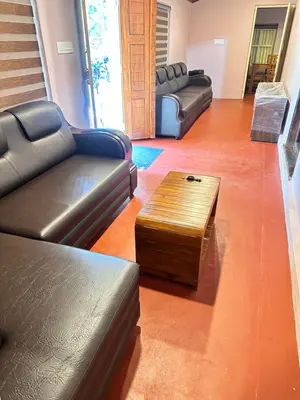 a living room with two couches and a coffee table at Bucolic Resort in Panamaram