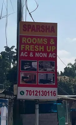 a sign for a restaurant on the side of a building at Sparsha rooms in Kaniyāmbetta