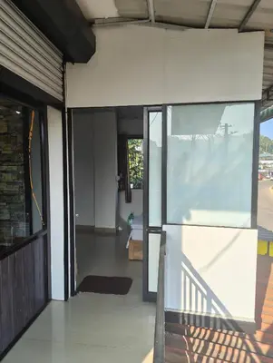 an open entrance to a house with a glass door at Sleek Haven in Meppādi