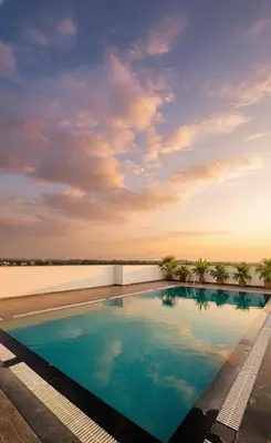 a swimming pool on top of a building at BOHO Living Kochi Airport in Ernakulam