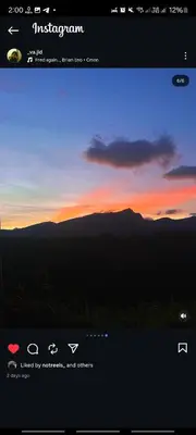 a computer screen with a picture of a sunset at Misty Colina in Kottakamboor