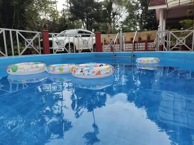 three inflatablelatable boats in a blue swimming pool at The Trio in Kalpetta