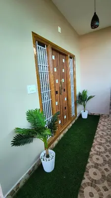 a room with two potted plants on the grass at Hideout luxe in Ooty
