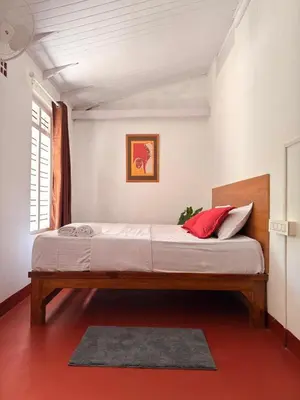 a bedroom with a large bed in a room at Avocado Orchards - Villa in Kenichira