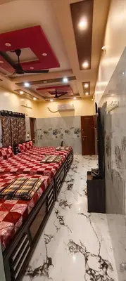 a bedroom with a large bed in a room with marble floors at Happy Holidays Cottage in Wodapatti