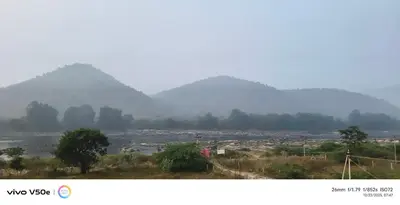 a view of a city with mountains in the background at Happy Holidays Cottage in Wodapatti